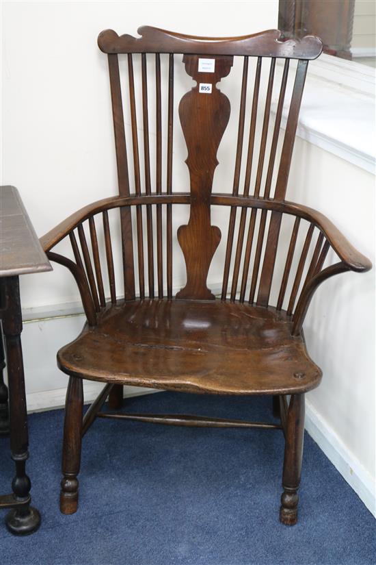 A mid 18th century Thames Valley elm and fruitwood comb back elbow chair